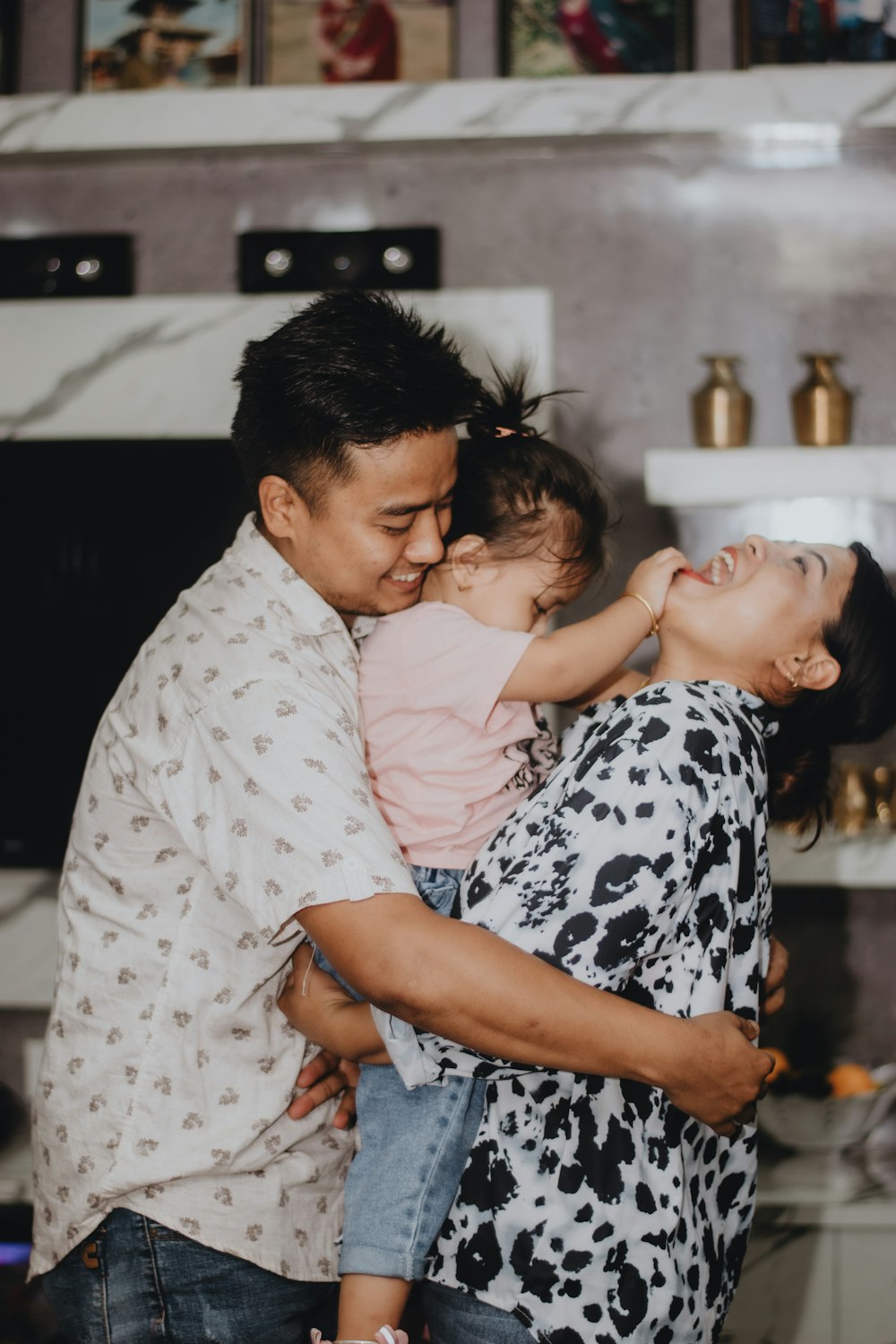 Young parents laughing with their little girl